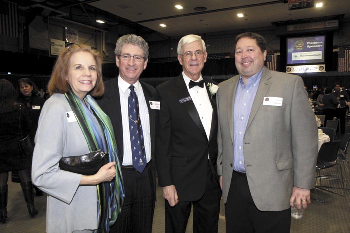 From left, Diane Doyen with husband and Augusta Mayor William Stokes, Kennebec Valley Chamber of Commerce President Peter Thompson and Scott Upham of Cribstone Capital Managagement at the Kennebec Valley Chamber of Commerce's annual awards banquet, at the Augusta Civic Center on Friday night.