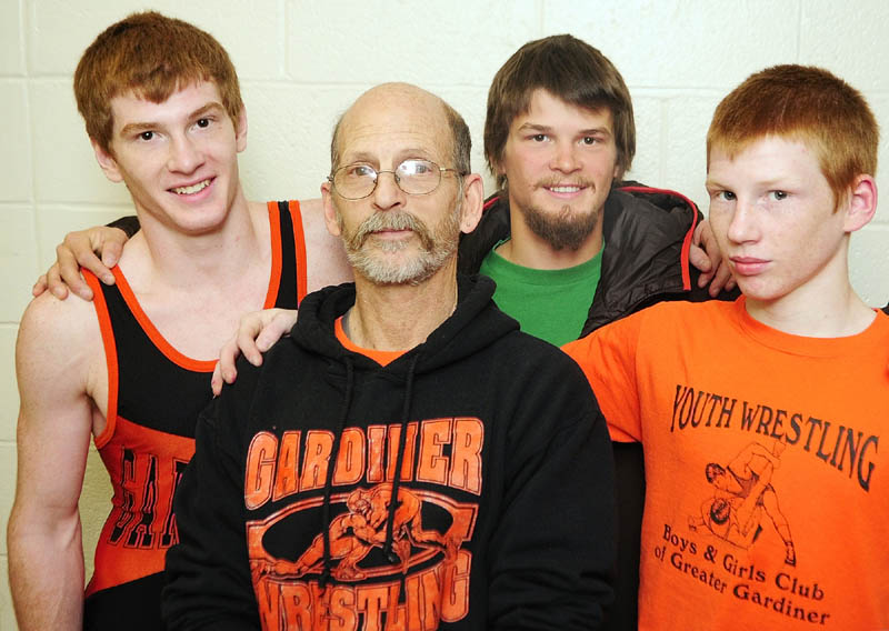 FAMILY PORTRAIT: Richard Del Gallo, center, is the father to sons Dan, left, Matt, back and Peter, a family that has enjoyed wrestlling success at Gardiner Area High School. Matt holds the record with 171 wins, a mark both Dan and Peter should challenge.