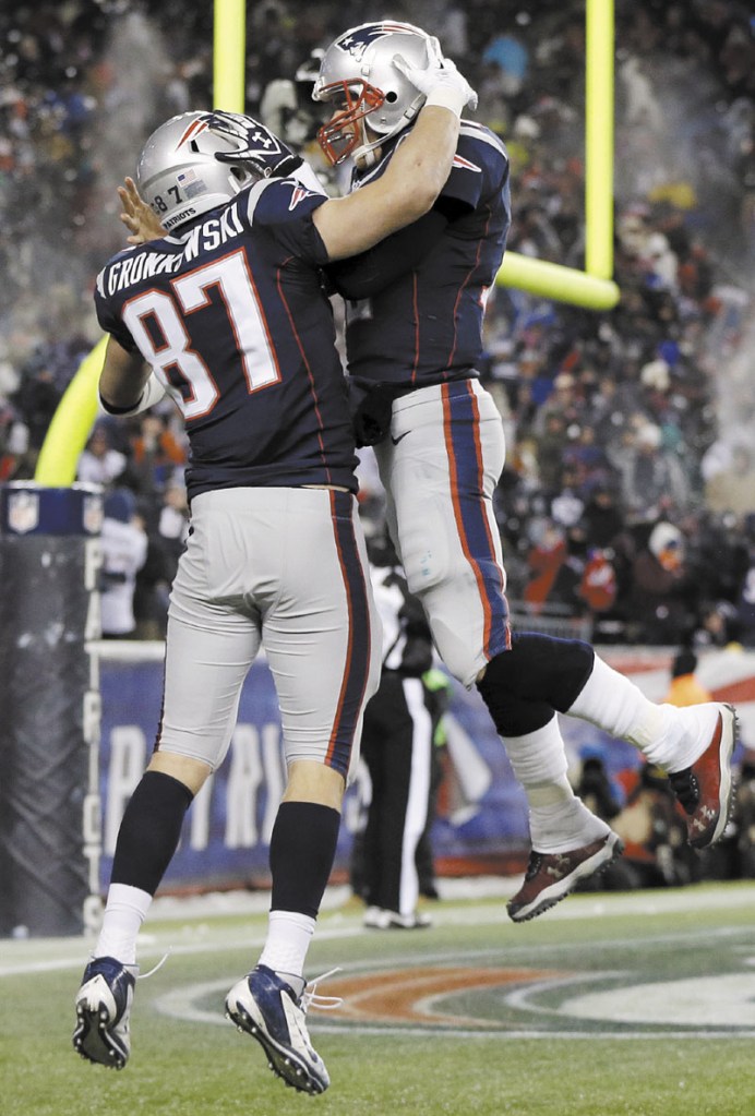 MORE TO CELEBRATE? New England Patriots quarterback Tom Brady, right, celebrates tight end Rob Gronkowski during a regular season game. The Patriots face the Houston Texans in an AFC divisional round game today in Foxborough, Mass. NFLACTION12; Gillette Stadium
