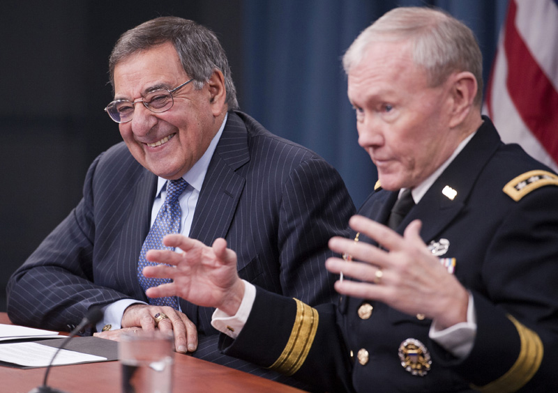 Defense Secretary Leon Panetta, left, and Joint Chiefs Chairman Gen. Martin Dempsey during a news conference at the Pentagon, Thursday, where Panetta announced he is lifting a ban on women serving in combat.
