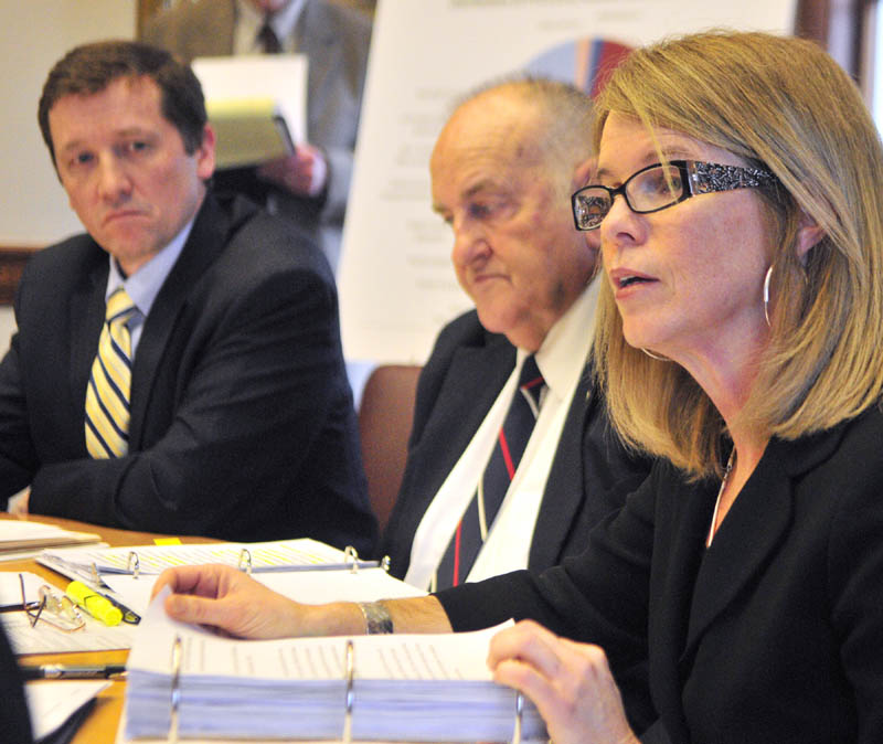 Education Commissioner Steve Bowen, left, Sawin Millett, commissioner of administrative and financial services, listen as Department of Health and Human Services Commissioner Mary Mayhew speaks during a news conference on Friday in the Cabinet Room of the State House in Augusta.