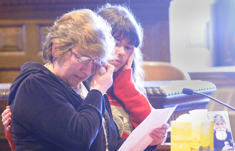 Janet Orr, left, is comforted by family friend Jodi Ferry as she speaks on Friday in Kennebec County Superior Courthouse in Augusta, during the sentencing of David Silva, who pleaded guilty of murdering her husband, Robert Orr, and burning down their Readfield home.