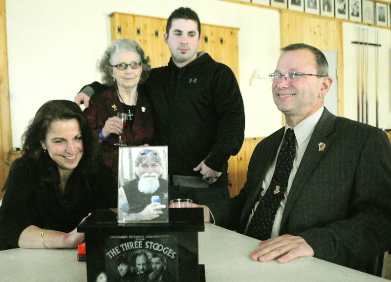At a luncheon after the sentencing hearing for David Silva, convicted of killing Robert Orr in 2011, Orr family members sit behind a photo and Robert Orr's urn, telling stories about the murdered man on Friday, at the Alfred W Maxwell Jr. Post 40 American Legion hall in Winthrop. They are from left, Nancy Mooney, sister, Emily Orr, mother, Robert Orr, son, and Raymond Orr, brother.