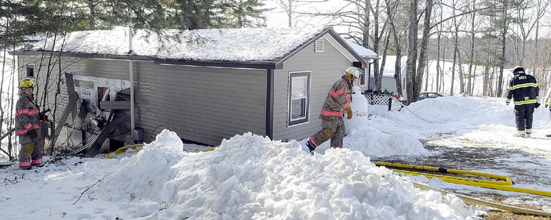 After knocking down the fire earlier, firefighters continuing work Tuesday morning at 769 Plains Rd. in Litchfield.