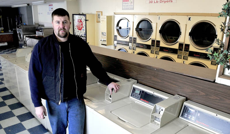 David Folsom stands inside the closed Butler's Cleaners in Skowhegan on Tuesday. Folsom is planning to reopen the store in mid-March and offer laundry services and a used auto lot.
