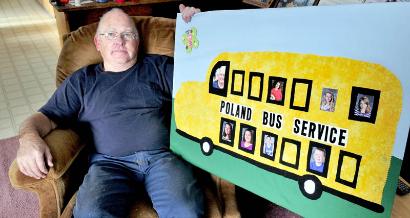 Gib Poland, of Cornville, sits back with a sign he received from his daughter and grandchildren, after a recent retirement party celebrating his 47 years as a school bus driver.