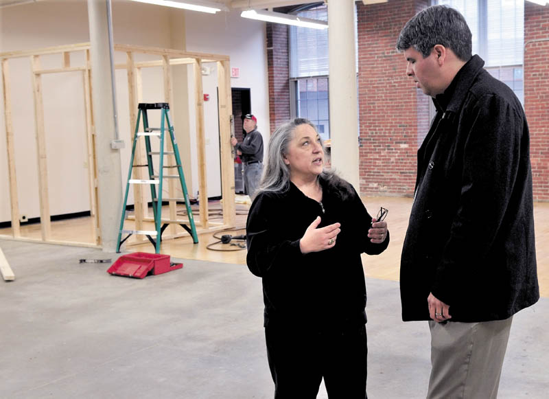 Maureen Hibler speaks with Thomas McCowan inside her Button Down Cafe, being constructed inside the Hathaway Creative Center in Waterville, on Thursday.