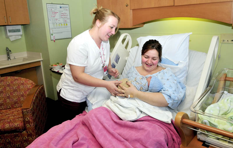 Sarah Ward holds her newborn son, Saul, as Inland Hospital Birthing Center nurse Heidi Presti looks on on Thursday. Inland was one of eight hospitals in the state that were recognized as a Best Hospital for Obstetrics by WomenCertified. Ward said she was happy enough with the care she receives at Inland that she had her second child at the Waterville hospital.