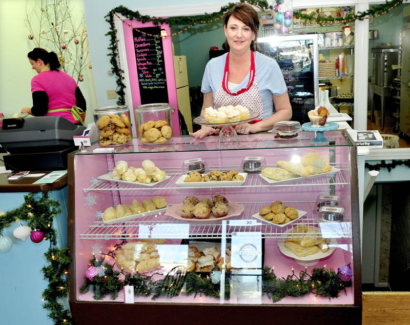 Sharalyn Albertson stocks a display case with baked goods she and Janet Johnson, left, make, recently at the Blessed Life Bakery in Waterville.