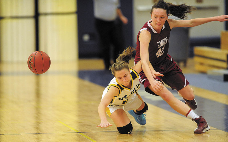 MAKING AN EFFORT: Mt. Blue High School’s Mackenzie Conlogue, left, battles for the loose ball with Bangor High School’s Mary Butler in the second quarter of the Cougars’ 49-42 win Thursday in Farmington.
