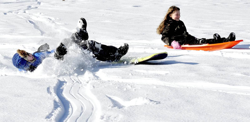 Madia Chesner, right, finished her sled ride in style while friend Ricky Hallowell came to an abrupt end while sledding with family at the Pinnacle in Pittsfield on Thursday, Jan. 17, 2013.