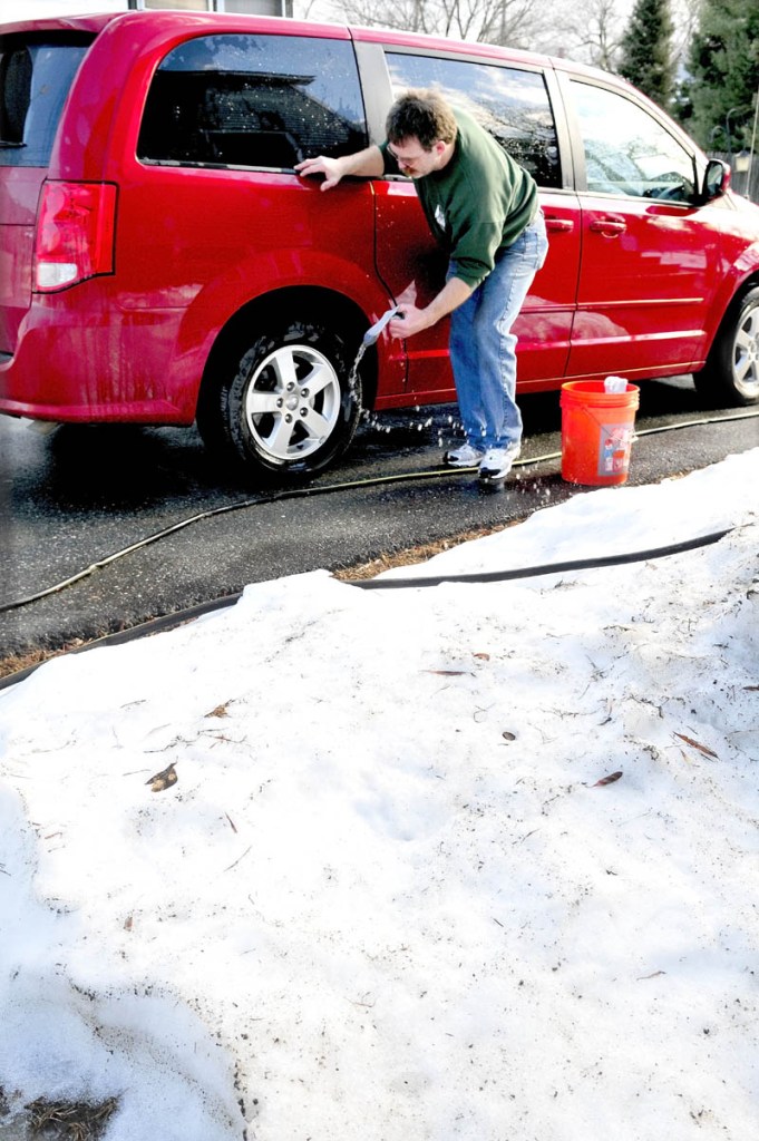 Tom McCormick washes his van in Waterville as temperatures rose above 50 degrees on Monday. "I don't mind this weather; at least you don't have to shovel humidity," McCormick said.