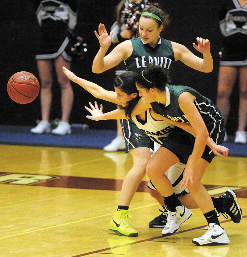 Nokomis High School's Lacey Kent-Webber, 10, battles for the loose ball with Leavitt High School's Meagan Dow, 5, foreground and Sierra Santomango, 23, background in the fourth quarter in Newport Thursday.