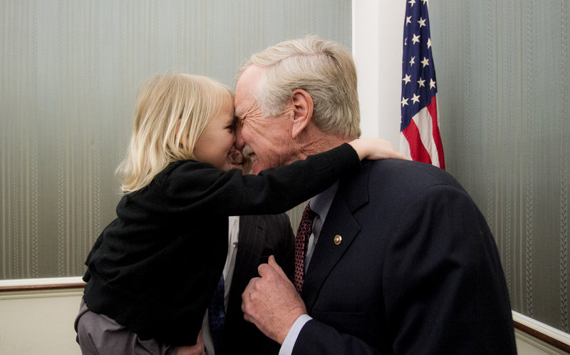 Sen. Angus King receives a hug from his granddaughter, Maya, 4, during a reception following his official swearing-in ceremony at the Capitol in Washington on Thursday.