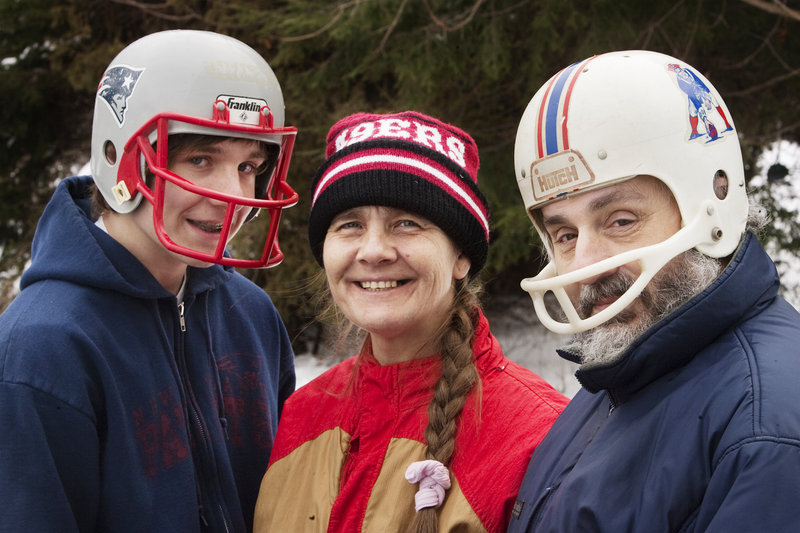 The Clement family, Bert, 17, Cathy and Bill, of South Portland, wear their New England Patriots headgear on Saturday, in anticipation of Sunday's AFC Championship game against the Baltimore Ravens.