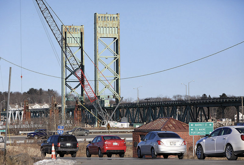 In this photo made Wednesday, Jan. 23, 2013, traffic backs up in Portsmouth, N.H., after the lift span on Sarah Mildred Long Bridge became stuck about a foot from its normal position. Work was started on Thursday to fix the lift bridge between New Hampshire and Maine. (AP Photo/Ioanna Raptis/Seacoastonline)
