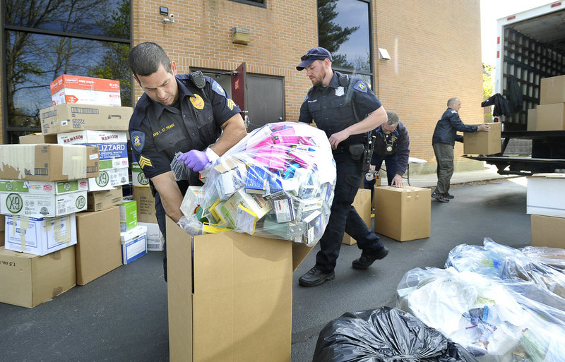 Lewiston Police Sgt. David St. Pierre and Officer Craig Johnson crate unused prescription drugs at the U.S. Drug Enforcement Administration’s Portland office April 28, 2012, during National Prescription Drug Take-Back Day.