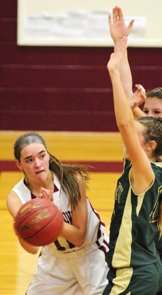 DISH IT OFF: Richmond’s Jamie Plummer, left, looks to pass around Rangeley defender Abby Abbott during the Bobcats’ 50-37 win Tuesday in Richmond.