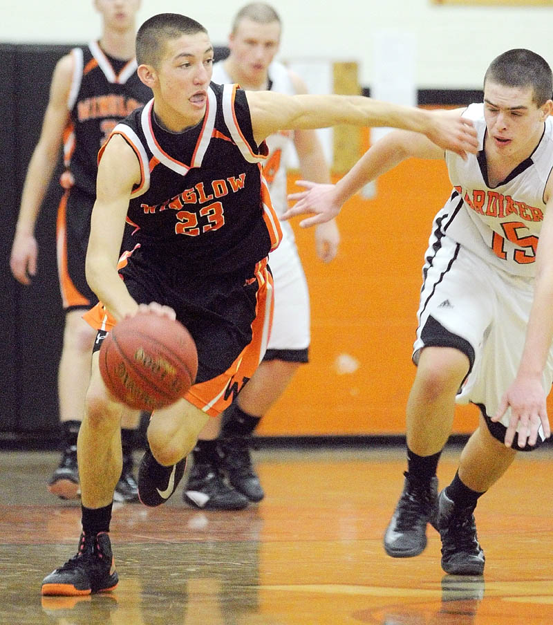 PASS ON BY: Winslow’s Nason Lanphier, left, is covered by Gardiner’s Jensen Orewiler on Saturday at the John A. Bragoli Memorial Gym in Gardiner. Winslow won the game 58-48.
