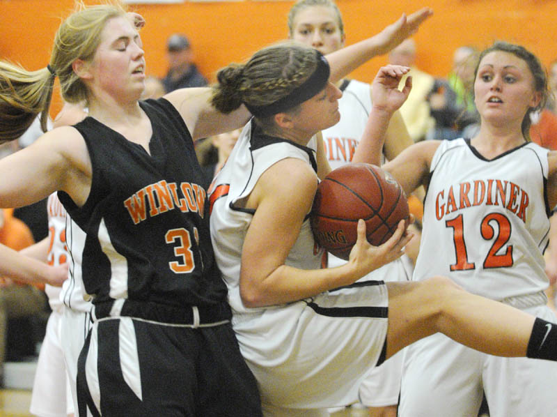 Winslow's Megan Richards, left, Gardiner's Ally Day along teammate Taylor Banister go up for a rebound during a game on Saturday at the John A. Bragoli Memorial Gym in Gardiner.
