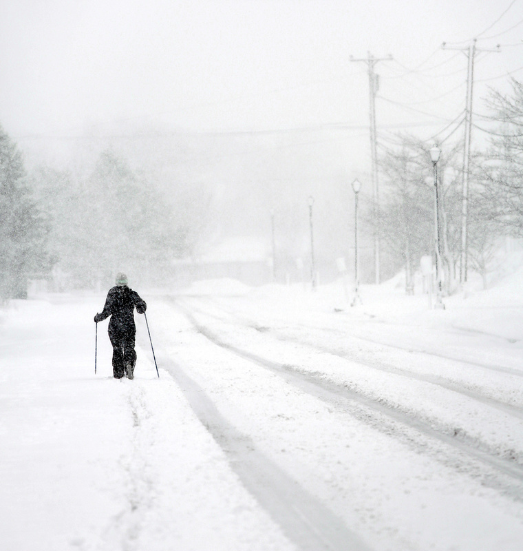 Leigh Turitz of South Portland skis down Madison Street in South Portland during the heavy snowfall Sunday morning.
