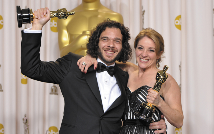 Sean Fine, left, and Andrea Nix Fine pose with their award for best documentary short subject for "Inocente" during the Oscars at the Dolby Theatre on Sunday.