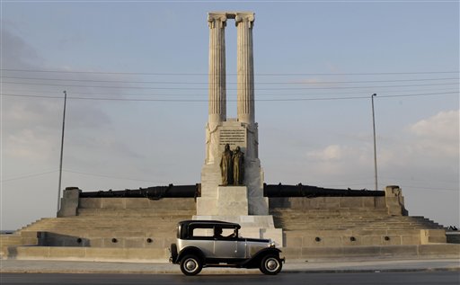A classic car drives past the restored USS Maine monument in Havana, Cuba, on Tuesday. The monument was erected in 1925 in honor of U.S. sailors who died in 1898 when the USS Maine ship sank off Havana Harbor.