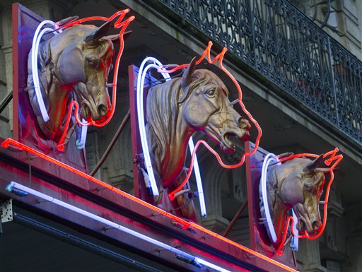 Three statues of horses' heads advertise a horsemeat butcher shop in Paris, on Friday. French Consumer Affairs Minister Benoit Hamon said Thursday that it appeared fraudulent meat sales over several months reached across 13 countries and 28 companies. He identified French meat wholesaler Spanghero as a major culprit.