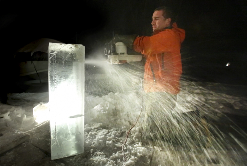 Ice sculptor Jesse Bouchard uses an electric chainsaw to cut out a detail area on a block of ice at his South Portland home on Tuesday. The blocks will be constructed into an ice bar at the Hilton Garden Inn in Freeport on Friday night.