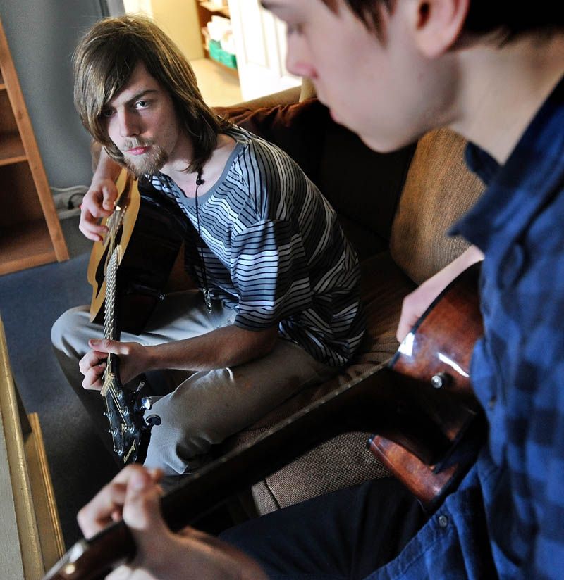 Alex West, 17, left, jams with his friend, Tim Thompson, 16, at their residence hall cottage on the Good Will-Hinckley campus in Hinckley on Wednesday. Gov. LePage spoke about West during his State of the State address in Augusta Tuesday night.