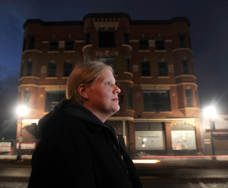 Kerri Marion, 28, of Fairfield, has been photographing the renovations of the Gerlad Hotel on Main Street in Fairfield, seen in the background.