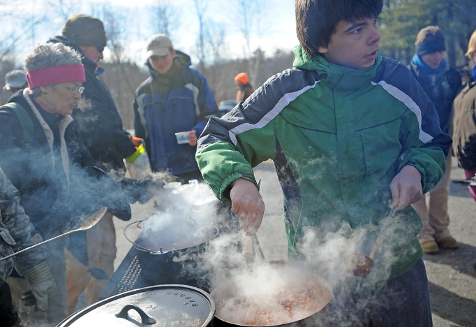 Cody Curtis, 16, of Skowhegan, stirs a batch of his "dulce a pico" chili at the annual chili cookoff, at the Winter Festival at Lake George on the Skowhegan and Canaan town line, on Saturday.