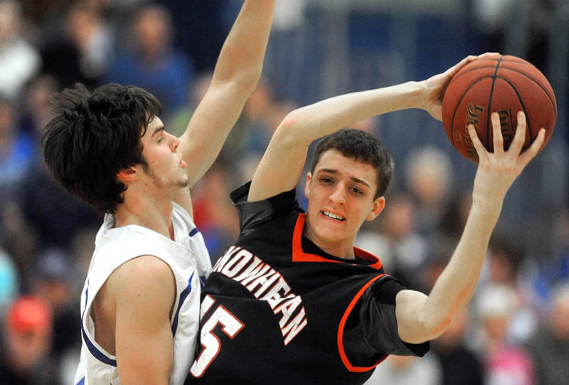 PRESSURE D: Lawrence High School’s Nick Noiles, left, defends Skowhegan Area High School’s Riley Teixeira in the second quarter Wednesday in Fairfield.