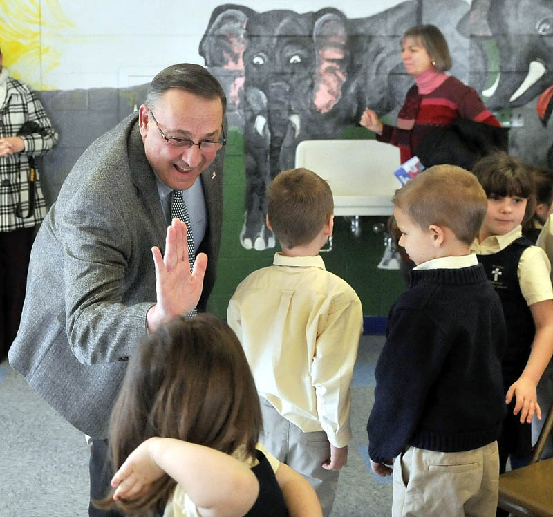 Gov. Paul LePage greets students after reading "Baxter at the Blaine House" to the student body at St. John Regional Catholic School in Winslow on Friday.