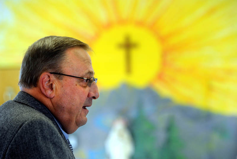 Gov. Paul LePage reads "Baxter at the Blaine House" to the student body as part of the 2013 Catholic Schools Week celebration at St. John Regional Catholic School on South Garand Street in Winslow on Friday morning.