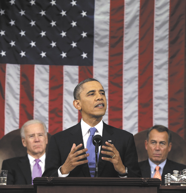 President Barack Obama, flanked by Vice President Joe Biden and House Speaker John Boehner of Ohio, gestures as he gives his State of the Union address during a joint session of Congress on Capitol Hill in Washington on Tuesday. Obamas re-election and his urging of new restrictions on gun ownership have spurred a run on concealed-weapons permit applications in Maine, according to many.