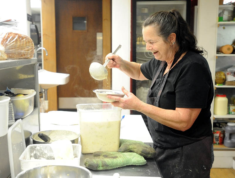 Karen "Kiki" Beane serves some corn chowder while working the kitchen at Thompson's restaurant on Main Street in Bingham on Wednesday.
