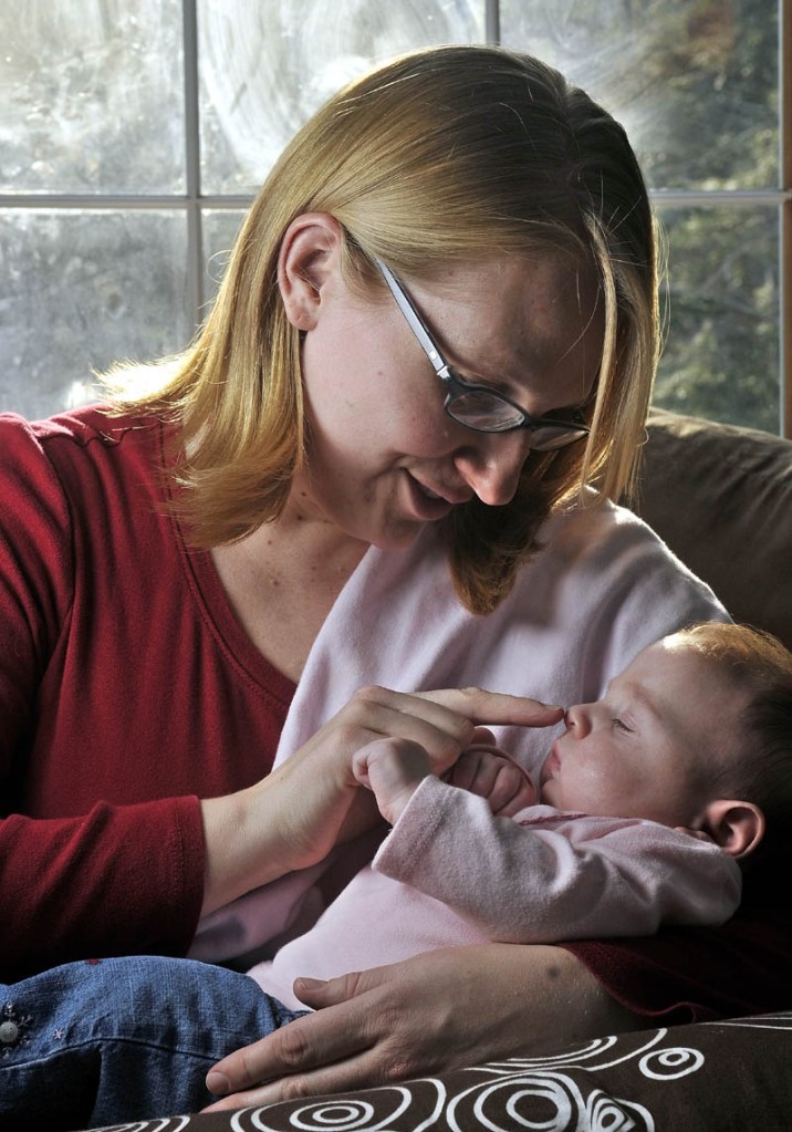 Thomasina Hutchins sits with her daughter, Eva, 3 months, at home in Winthrop on Friday.