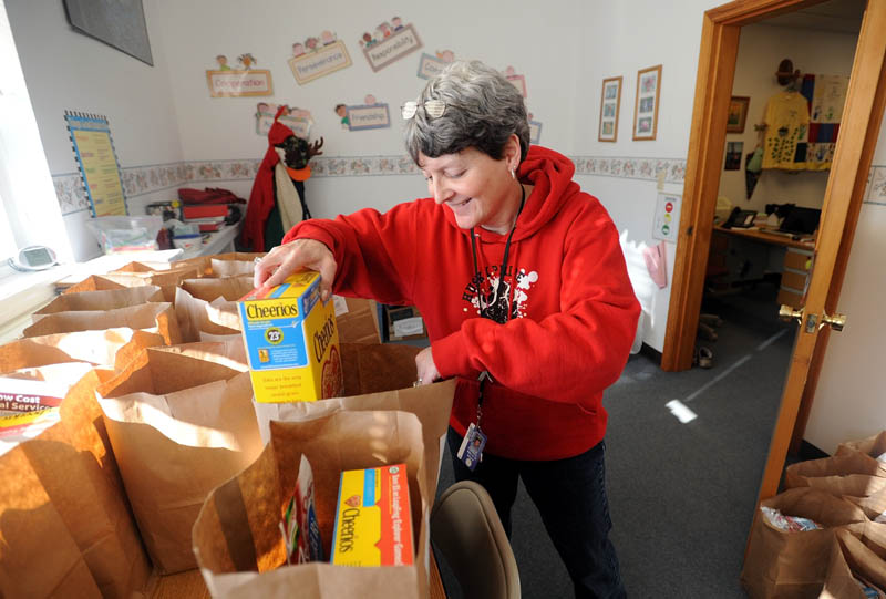 Denise Kimball, principal at Hartland Consolidated School, packs snack bags recently, to be distributed to families to help meet the nutritional needs of children over February break.
