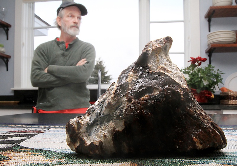 Rye, N.H. fisherman Mike Anderson says he pulled up a mammoth tooth from the depths of the ocean Tuesday, Feb. 19, 2013. Anderson said he was fishing for scallops near Rye Harbor on Tuesday. He noticed a 6-inch-long, triangular object mixed in with the scallop shells and rocks. Will Clyde, a University of New Hampshire associate professor of geology, says it may be a fossil mammoth tooth. (AP Photo/Portsmouth Herald, Ioanna Raptis)