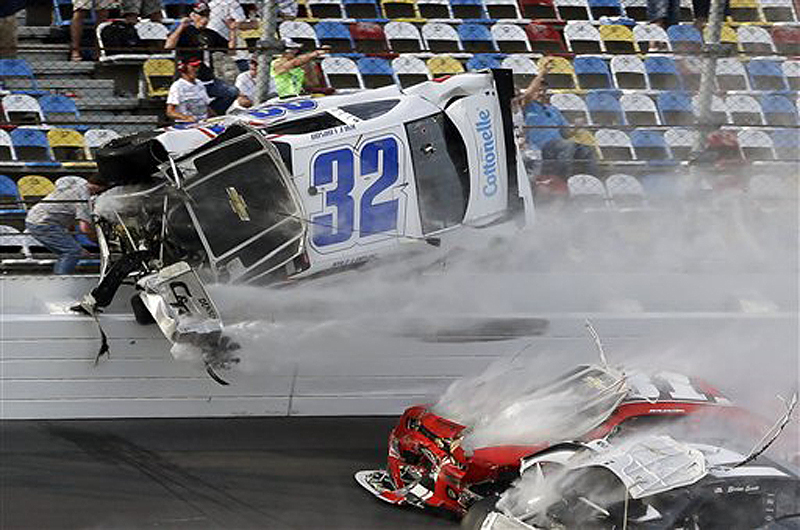 Kyle Larson (32) goes airborne and into the catch fence during a multicar crash involving Justin Allgaier (31), Brian Scott (2) and others during the final lap of the NASCAR Nationwide Series auto race Saturday at Daytona International Speedway in Daytona Beach, Fla. The crash sent car parts and other debris flying into the stands, injuring spectators.