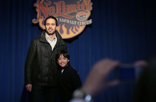 NASCAR driver Jimmie Johnson, left, poses for a photo with racing fan Sam Valenti, 10, during an event at the House of Blues in Dallas, Wednesday, Feb. 27, 2013. Johnson's whirlwind week as Daytona 500 champion continues with an appearance in downtown Dallas. It will be the third state and second time zone Johnson has visited since Sunday's win, and he has to race this weekend in Phoenix. (AP Photo/LM Otero)