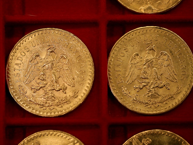 Mexican 50 peso pieces were among the $3.5 million in gold coins auctioned off in Carson City, Nev., on Tuesday, Feb. 26, 2013. Recluse Walter Samaszko died in June 2012, leaving thousands of coins hidden in his garage. (AP Photo/Las Vegas Review-Journal, Cathleen Allison)