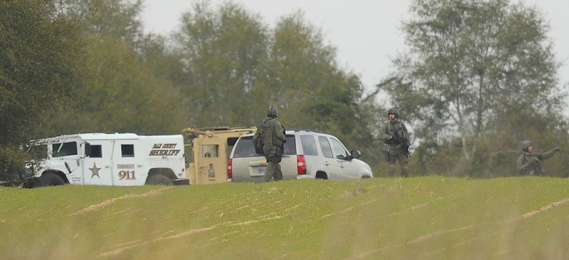 Armed law enforcement personnel station themselves near the property of Jimmy Lee Sykes, Monday, Feb. 4, 2013 in Midland City, Ala. Officials say they stormed a bunker in Alabama to rescue a 5-year-old child being held hostage there after Sykes, his abductor, was seen with a gun. (AP Photo/AL.com, Joe Songer) Midland city shooting