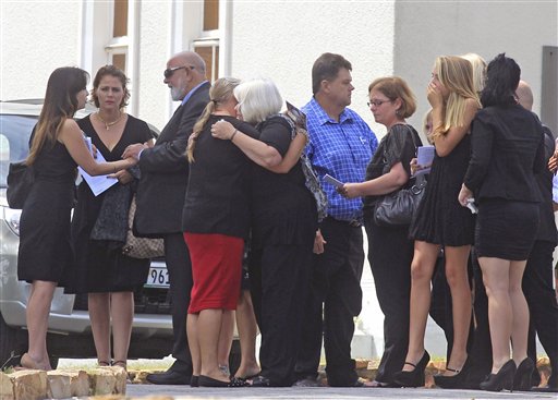 Barry Steenkamp, third left, the father of Reeva Steenkamp, greets people as he and others attend her funeral, in Port Elizabeth, South Africa, on Tuesday.