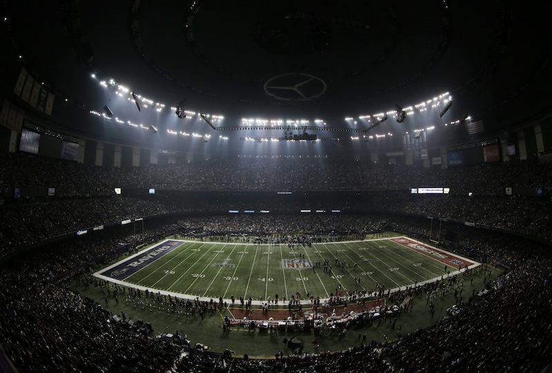 Fans and members of the Baltimore Ravens and San Francisco 49ers wait for power to return in the Superdome during an outage in the second half of the NFL Super Bowl XLVII football game on Sunday.