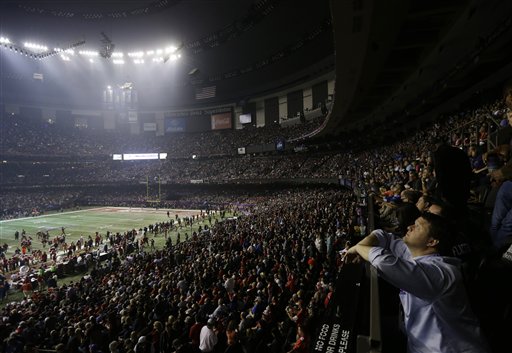 Fans and members of the Baltimore Ravens and the San Francisco 49ers wait for power to return in the Superdome during an outage in the second half of the NFL Super Bowl XLVII football game on Sunday.