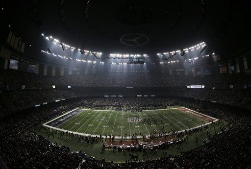 Fans and members of the Baltimore Ravens and San Francisco 49ers wait for power to return in the Superdome on Sunday, Feb. 3, 2013, during an outage in the second half of the Super Bowl.