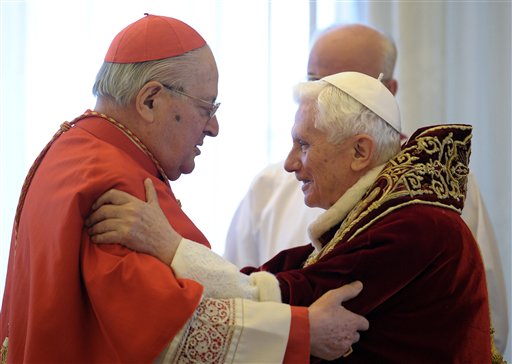 Pope Benedict XVI, right, and Cardinal Angelo Sodano, Dean of the College of Cardinals, hug each other on Monday after the pontiff announced during the meeting of Vatican cardinals that he would resign on Feb. 28.