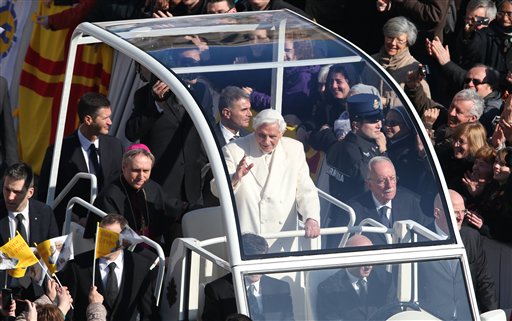 Pope Benedict XVI greets pilgrims in St. Peter's Square at the Vatican on Wednesday for the final time before retiring, waving to tens of thousands of people who have gathered to bid him farewell. At one point he stopped to kiss a baby handed up to him by his secretary.
